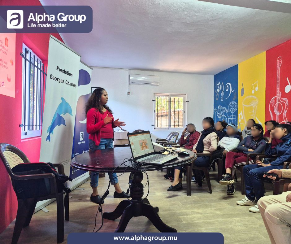 Alpha Hygiene staff member discussing the importance of sanitary bin service and menstrual care with students at Fondation Georges Charles